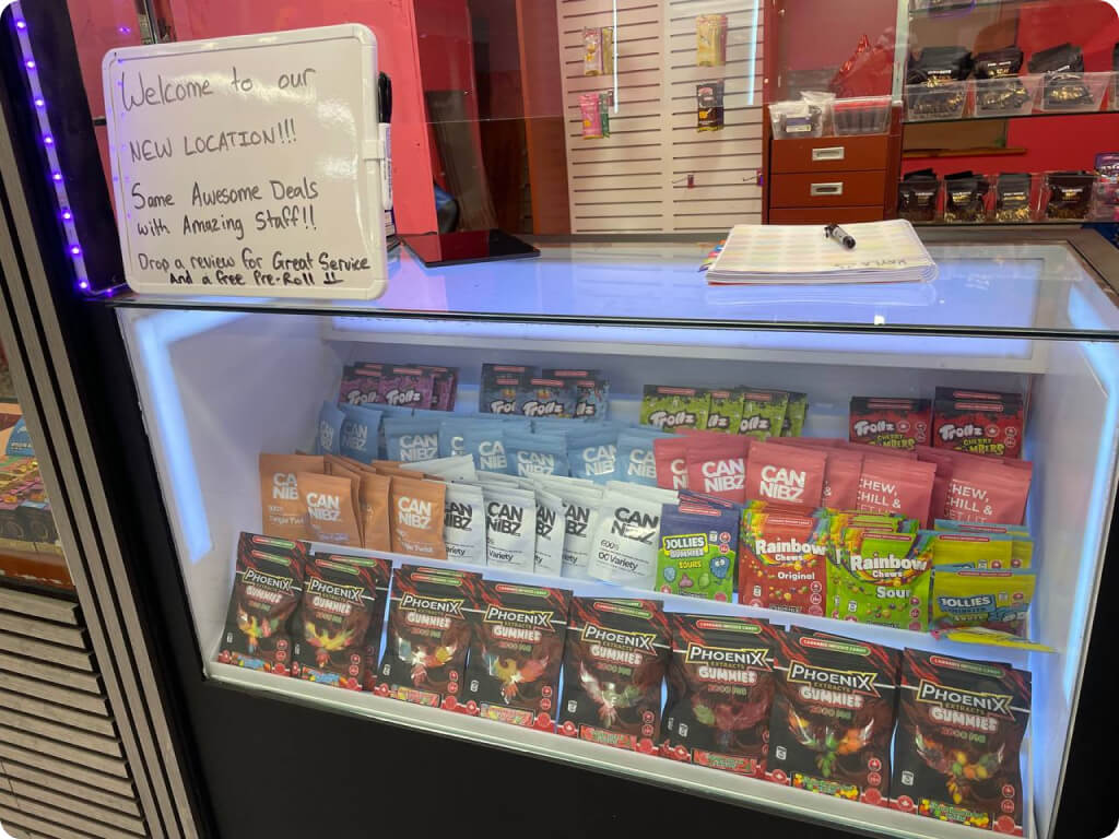 Edibles display case with Phoenix gummies, Cannibz, Trollz, and Rainbow chews