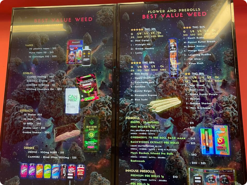 Digital menu boards showing flower, vapes, edibles, extracts and pre-roll pricing