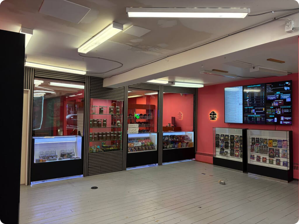Best Value Weed interior — pink-walled retail floor with product displays and digital menu boards